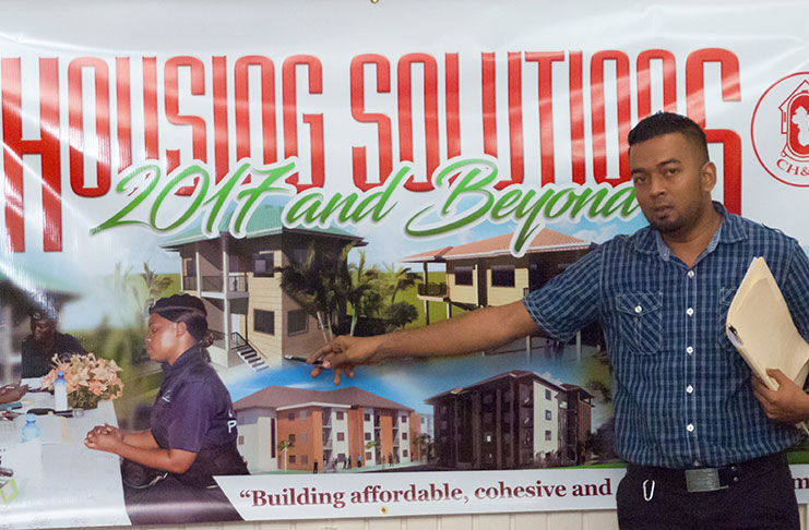 Project Director “Housing Solutions 2017 and beyond” Omar Narine points to images of some of the homes to be constructed at the Perseverance model village (photo by Delano Williams)