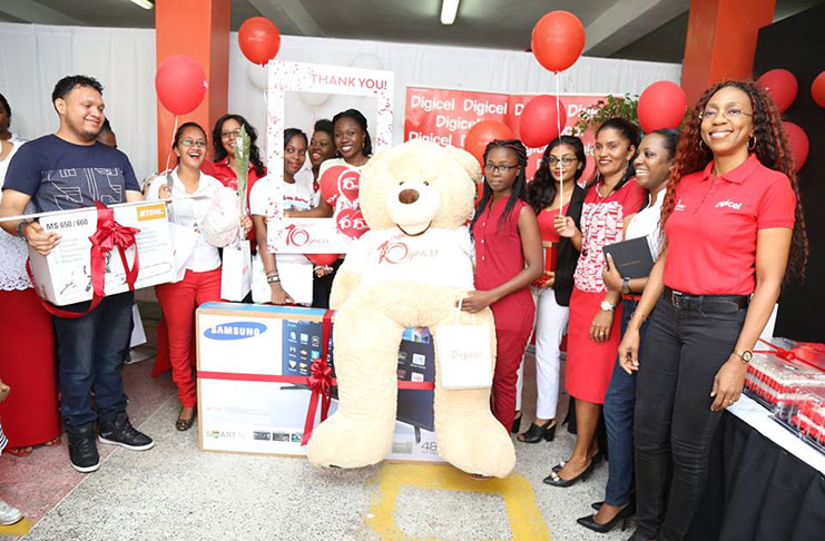 The winners posing with the gifts at Digicel’s Kingston HQ yesterday