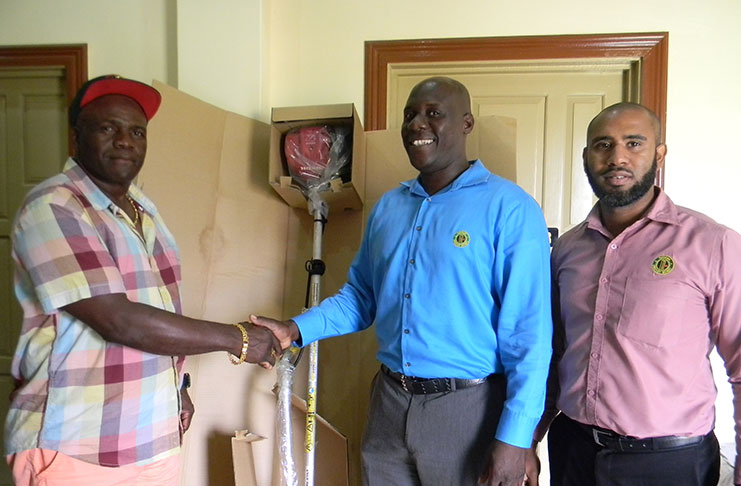Lancelot Easton (left), president of Bayroc Club, receives the equipment from GCB’s Territorial Development Officer, Colin Stuart, in the presence of GCB’s Assistant Territorial Development Officer (TDO) Anthony D'Andrade.