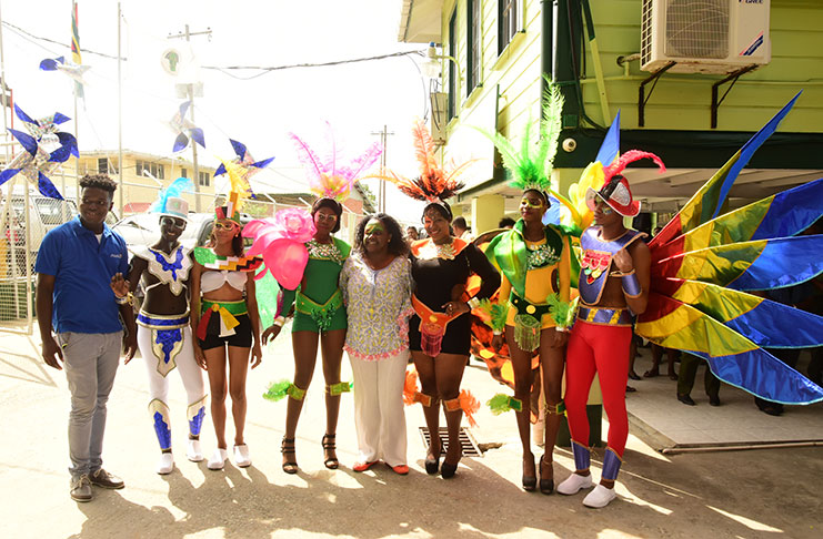 Mash Band Designer, Neilson Nurse (left) with Junior Minister within the Ministry of Natural Resources Simona Broomes (fourth from right) and the models in the Ministry’s Mash costumes (Adrian Narine photo)