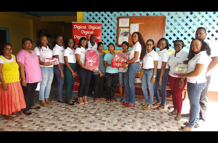Residents of the Prabhu Sharran Orphanage receive hampers and other items from Digicel Guyana