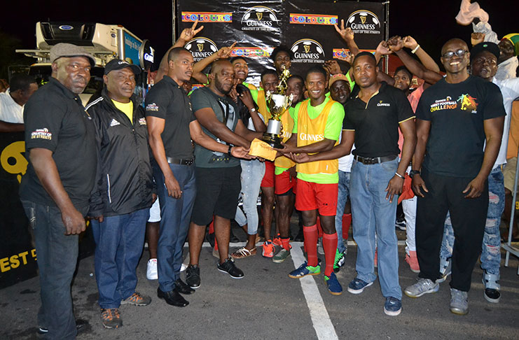 The winning Showstoppers team poses with their cash and trophies following their 2-0 win over hustlers in the finals of the West Demerara Guinness Greatest in the Street football competition. (Stephan Sookram Photo)