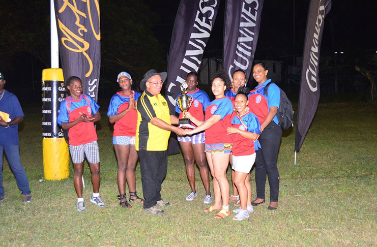 GRFU President, Peter Green,  hands over the winners’ trophy to the ladies captain following their win in the Guinness VII’s final last evening.