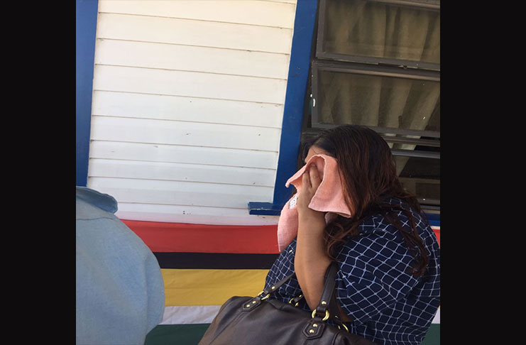 Suspected mastermind, Indira Outar hides her face as she leaves the Whim Magistrate’s Court