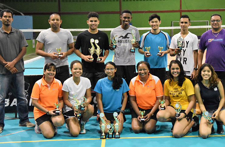 The respective top finishers in the GUMDAC sponsored Badminton tournament display their prizes after the presentation,along with officials.