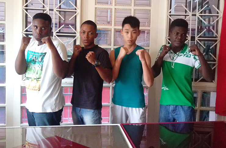Suriname’s four boxers,who will be coming up against their Guyanese counterparts tonight at the National Gymnasium,strike a pose after yesterday’s press conference.