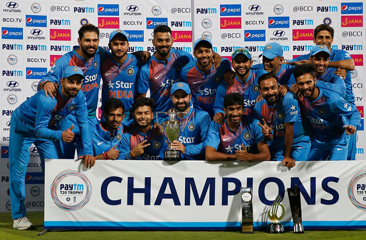 Indian team pose with the trophy after winning the T20I series against England at Bangalore yesterday. (Associated Press)