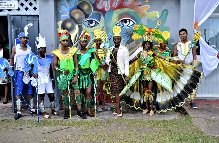 Minister within the Ministry of Education, Nicolette
Henry poses with staff of her ministry during Tuesday’s
launch of their 300-strong full costume revelers Mash
band, themed “Guyana an emerging green state.” The
costumes and float were designed by the E.R Burrowes
School of Art
