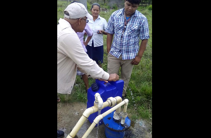 GWI Rep. Mr. Mark Jeffrey, demonstrating how to use the Life Saver Jerrycans at Shea Village