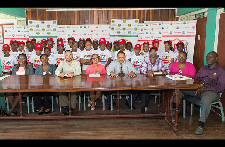 (Seated from right) Colin Stuart, Hazel Pyle-Lewis, Gervy Harry, Drubahadur, Jennifer Cipriani, Nicholas Fraser, Lorna Mohammad and Taaliba Speede. Standing are some students and teachers of St Pius and Redeemer primary schools. (Samuel Maughn photo)