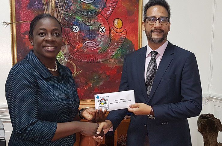 Junior Education Minister, Nicolette Henry,receives the sponsorship cheque from Republic Bank Managing Director, Richard Sammy
