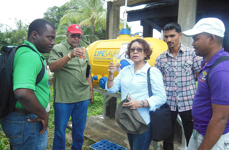 GWI’s Managing Director, Dr. Richard Van-West Charles and Minister within the Ministry of Indigenous People's Affairs, Valerie Garrido-Lowe raise their glasses to try the filtered water in Kamarang. Also in photo are: GWI’s Hinterland Manager, Osei Manifold (left), Dr. In-Charge of Upper Mazaruni District Hospital - Amitraj Persaud (second right) and GWI's Exec. Director – Mr. Ramchand Jailal (right)