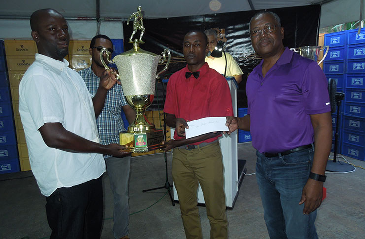 Silver Shattas’ coach Felix Inniss is seen collecting the trophy and cheque from George McDonald