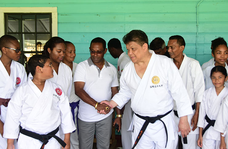Commander Cliffton Hicken and Sensei Frank Woon-a-tai shake hands during yesterday’s exhibition. (Adrian Narine Photo)