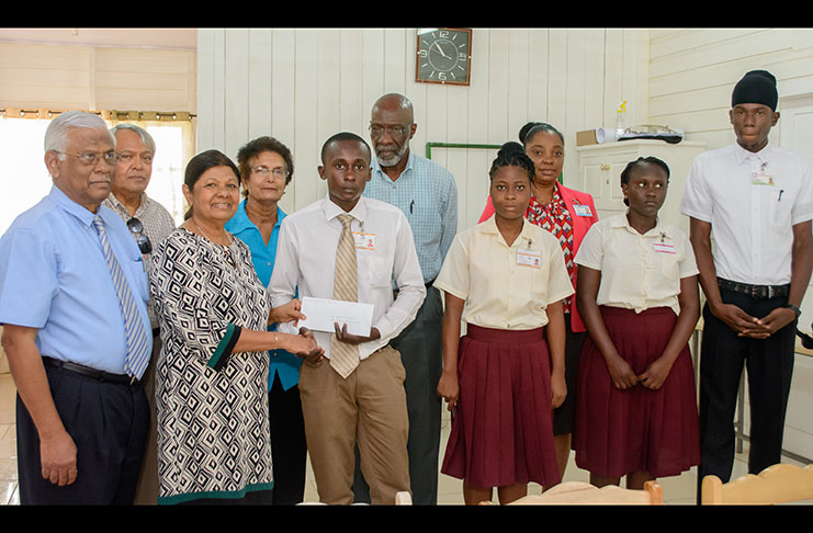 Gafoor Foundation Board member Ameena Gafoor presents an award to student Rondell Dazzell at the presentation on Wednesday. Others from left are Executive Chairman of Gafson’s Industries, Sattaur Gafoor; Mohamed Ali (Board member); Sylvia Conway (board member, Gafoor Foundation); Vincent Alexander, Chairman of the Board of Governors, (GTI); Alexandria Clarke (student); Principal (Renita Crandon) and Natasha Hunter and Leon Lewis (students)