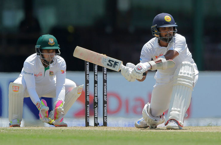 Dinesh Chandimal strikes his 12th Test fifty.