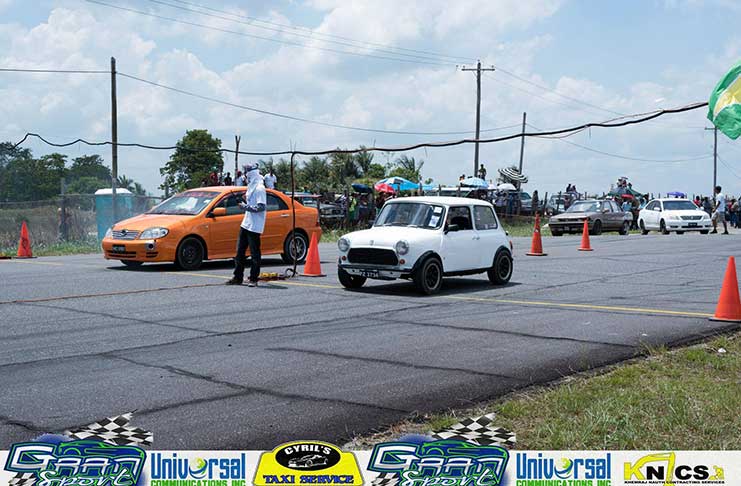 Marlon and his orange Toyota NZE (left) takes on an Austin Mini. (Sean Charles photo)