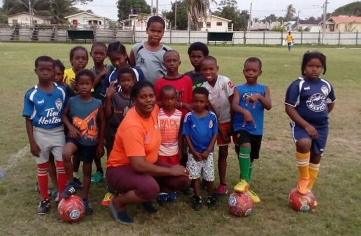 Nzinga Maxwell and young footballers