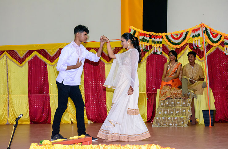Sixth form students acting as the grown Radha and Krishna (dressed in white) while another pair, acting as the God Krishna and Goddess Radha, look at their love story being acted out from their seat in the ‘heavens’ [Samuel Maughn photo]