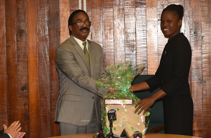 Attorney General and Legal Affairs Minister, Basil Williams presenting Latoya Roberts with the Guyana Government Prize – a collection of the Guyana Law Reports