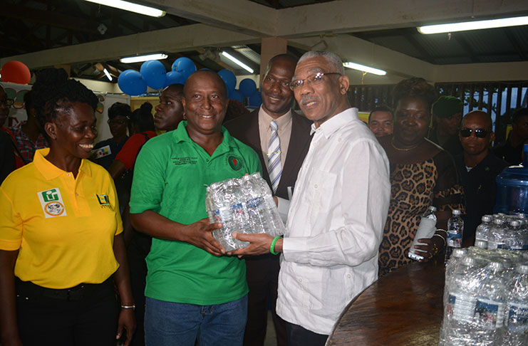 President David Granger with a young entrepreneur and his product