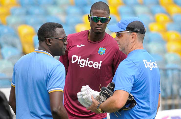 Planning strategy? Chairman of selectors Courtney Browne,  Skipper Jason Holder and Head coach , Stuart Law deliberate during a training session at Kensington Oval, yesterday. (Photo by WICB Media/Randy Brooks of Brooks Latouche Photography)