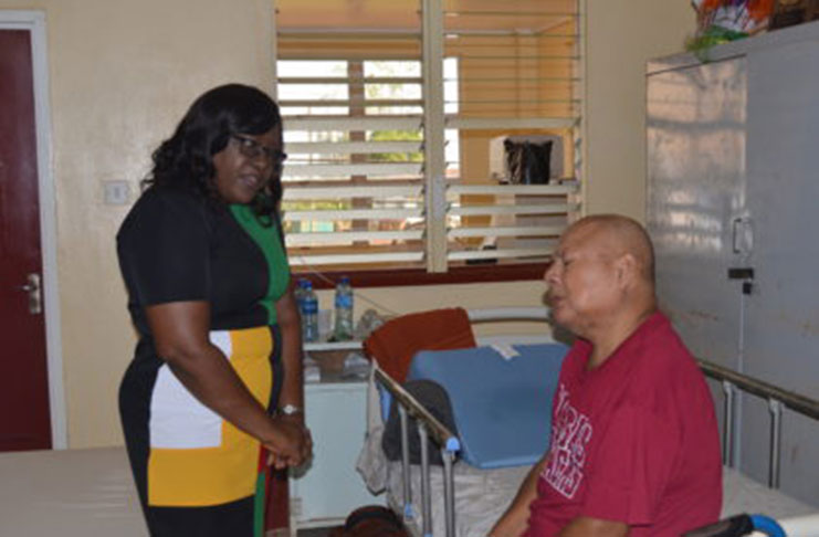 Minister within the Ministry of Public Health, Dr. Karen Cummings, with a patient at the Mabaruma Regional Hospital