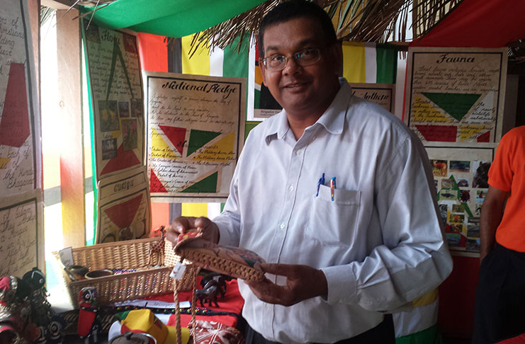 TAG Director, Mr. Indranauth Haralsingh shows keen interest a craft item