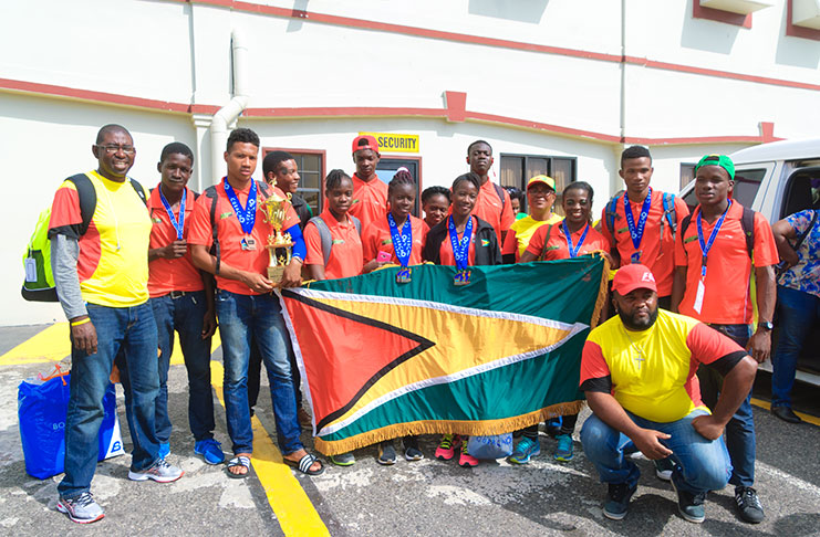 The Guyana team to the 2017 Flow CARIFTA Games after arriving home at the CJIA on Friday (Delano Williams photo)