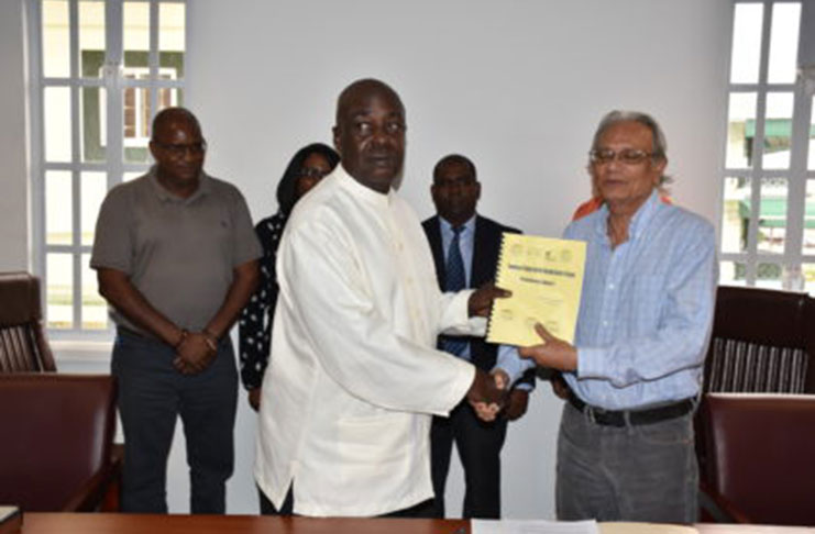 Education CoI Chairman Ed Caesar handing over the preliminary report to Education Minister Dr Rupert Roopnaraine on Friday