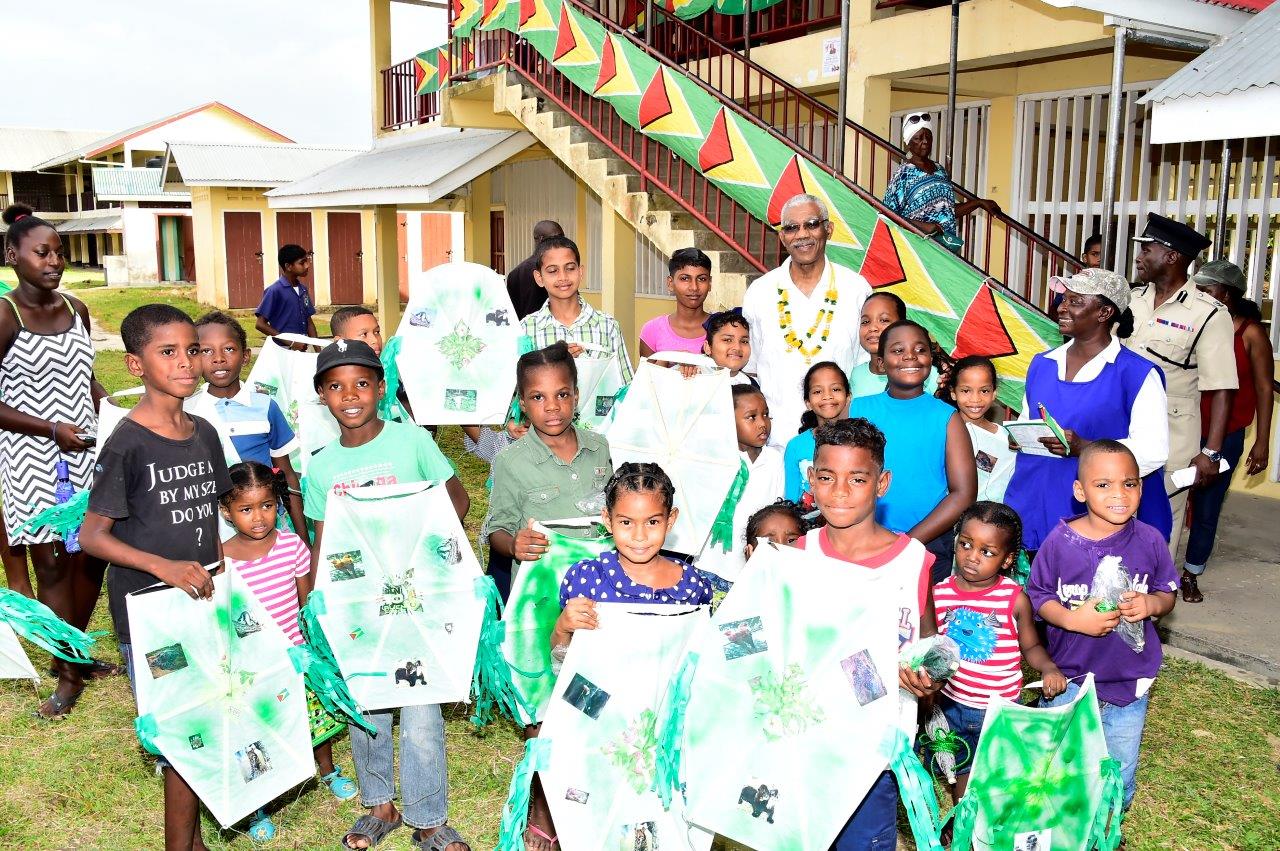 Big Smiles! President David Granger poses with the children of the Parika-Salem community