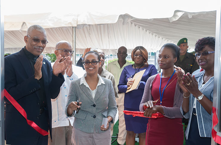 CAPTION: President David Granger and others applaud as a member of staff of the Bureau of Statistics cuts the ceremonial ribbon to open the new office at Main Street, Georgetown, on Friday (Photo by Delano Williams)