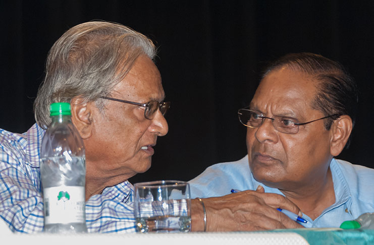 Prime Minister, Moses Nagamootoo and Education Minister, Dr Rupert Roopnaraine engage in discussion during the forum on Friday.