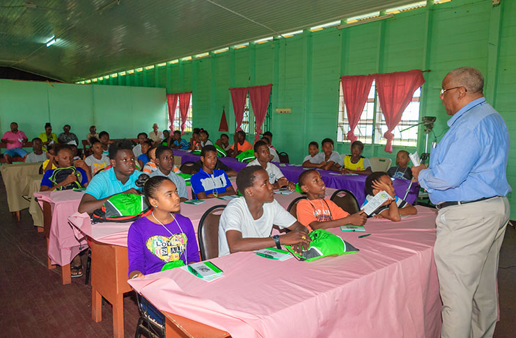 Secretary of the Pele Alumni Corporation, David `Doggy’ Chan, addresses the youths who attended yesterday’s opening day of the Corporation’s Youth Development Camp at the Carifesta Sports Complex. (Photo by Delano Williams)