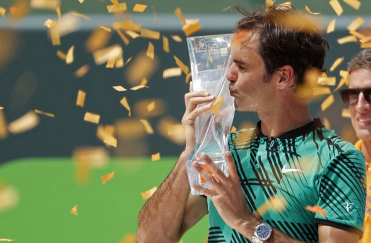 Roger Federer of Switzerland kisses the Butch Buchholz trophy after his match against Rafael Nadal of Spain (not pictured) in the men's singles championship of the 2017 Miami Open at Crandon Park Tennis Center. Mandatory Credit: Geoff Burke-USA TODAY Sports