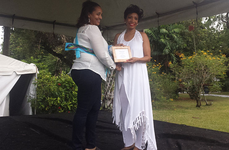 At the Autism  Fashion Show and Tea Party, on Saturday, Dr. Sonia Noel (right) presents a certificate to a supporter of the Sorsha Williams Foundation.
