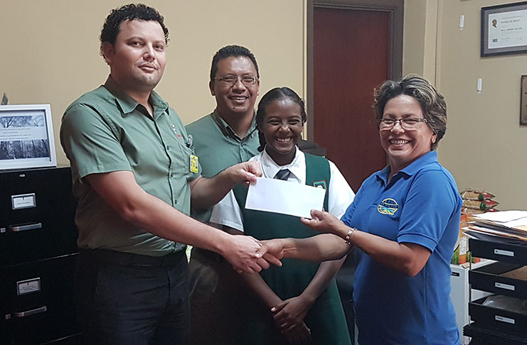An ecstatic Lian Winter (centre) and her dad Duane Winter (second from left) look on as her coach Stephanie Fraser (right) accepts the sponsorship package from a Bounty Farm Ltd representative.