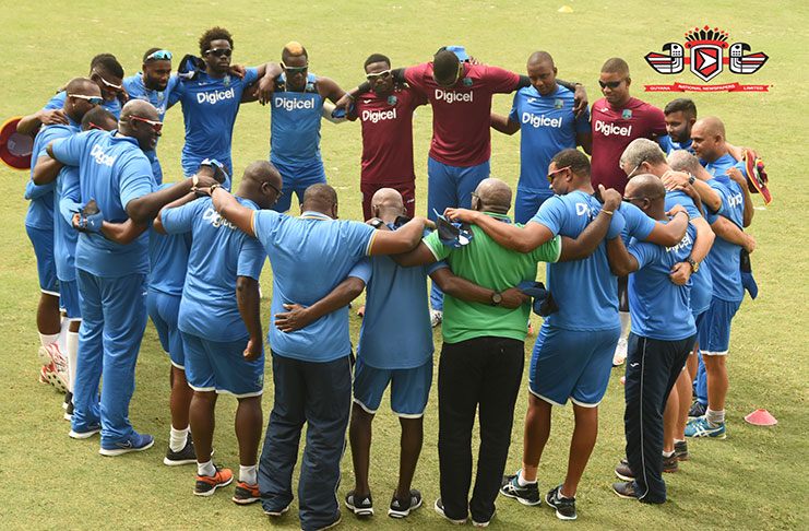 The West Indies team huddle for prayers  before their first practice session at the Guyana National Stadium on Tuesday (Adrian Narine photo)