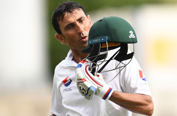 Pakistan batsman Younis Khan kisses his helmet after reaching the landmark on the third day at Sabina Park.