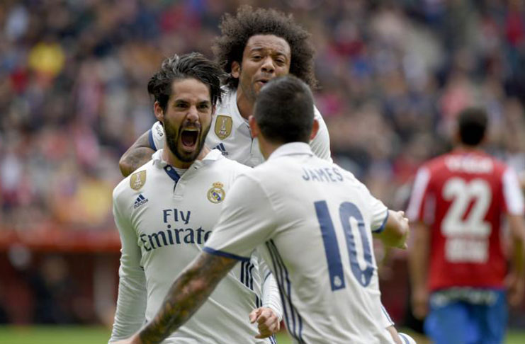 Real Madrid's Francisco 'Isco' Alarcon (L) celebrates with team mates Marcelo and James