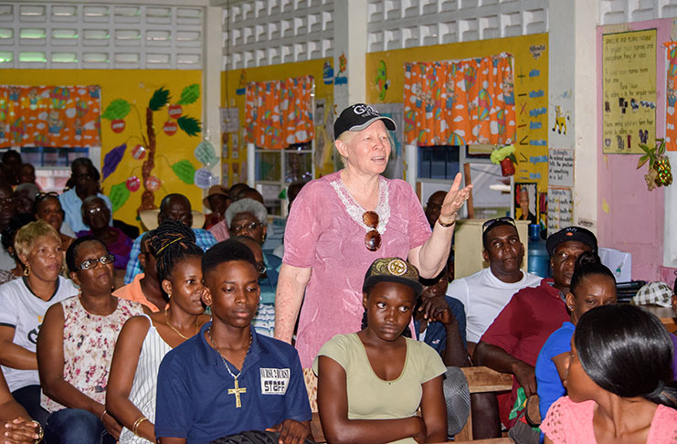 A resident poses a question to Minister of
State Joseph Harmon during the ministerial
outreach at Den Amstel Primary School,
West Coast Demerara on Sunday (Samuel
Maughn photo)