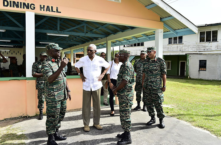 President David Granger being briefed on the Battalion’s operations by Chief of Staff, Brigadier Patrick West and Interim Base Commander, Captain Archer, while
the army’s Second in Command, Colonel Nazrul Hussain, looks on