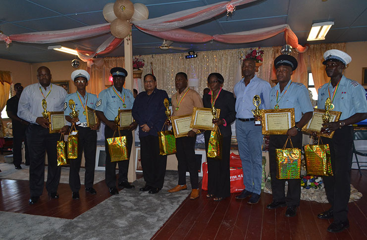 Prime Minister Moses Nagamootoo with cops who were awarded by the Rose Hall Town Youth and Sports Club on Sunday