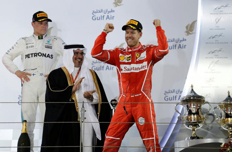 Ferrari Formula One driver Sebastian Vettel of Germany (R) celebrates after winning Bahrain Grand Prix. REUTERS/Hamad I Mohammed