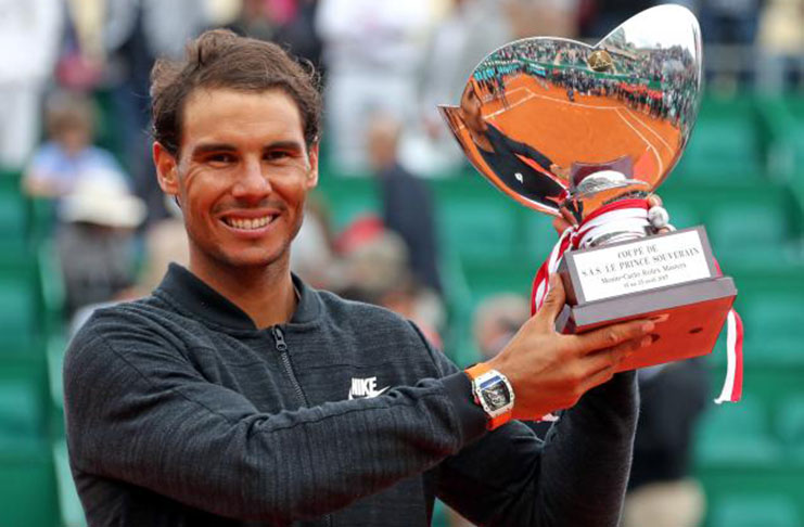 Rafael Nadal of Spain poses with his trophy after winning his final tennis match against his compatriot Albert Ramos-Vinolas at the Monte Carlo Masters. REUTERS/Eric Gaillard