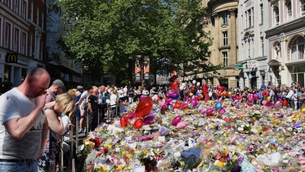 Flowers and tributes lined St Ann's Square in Manchester on Monday