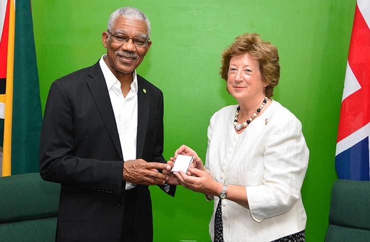The President receives a token from British Minister of State, Rt. Hon. Baroness Anelay during her visit