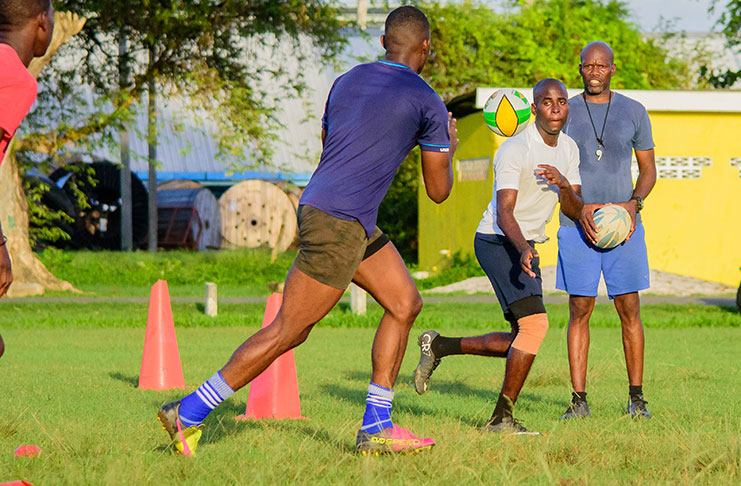 Green Machine head coach Kenneth Grant-Stuart (first from left) takes his team through training yesterday. (Samuel Maughn photos)