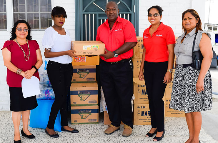 A Digicel representative (third right) hands over supplies to a representative of the Amerindian Peoples Association and the Civil Defence Commission (second left) on Wednesday