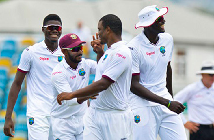 From left: Alzarri Joseph, Devendra Bishoo, Shannon Gabriel and Jason Holder celebrate victory in the second Test in Barbados. (WICB Media)